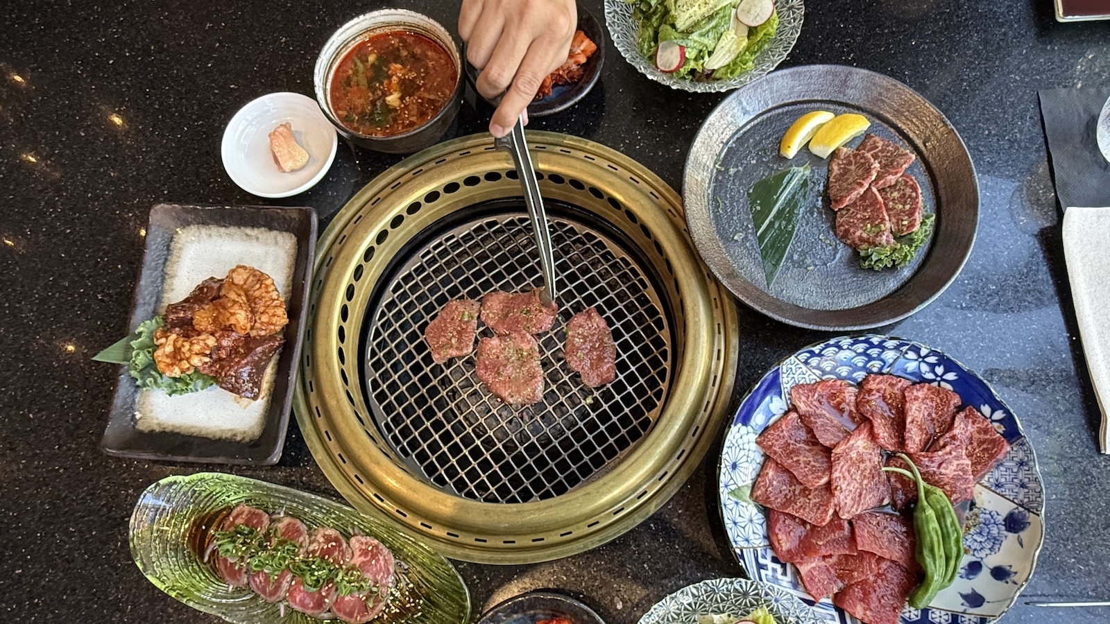 Sizzling yakiniku on a charcoal grill